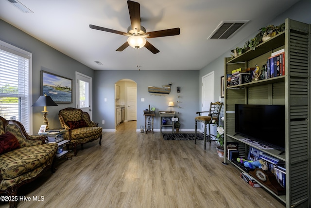 sitting room featuring wood-type flooring and ceiling fan