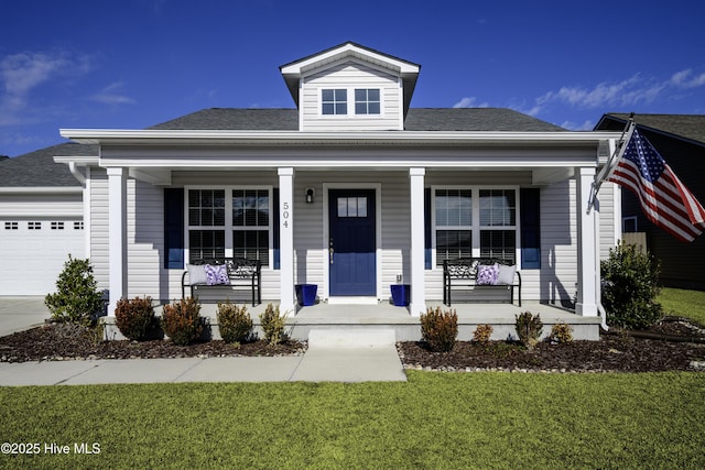 view of front facade featuring a porch, a garage, and a front lawn