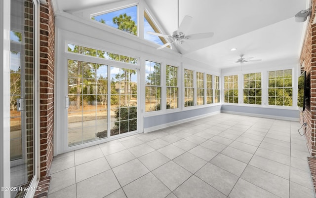 unfurnished sunroom featuring ceiling fan and vaulted ceiling