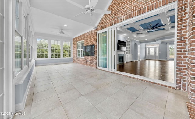 unfurnished sunroom featuring lofted ceiling, coffered ceiling, and ceiling fan