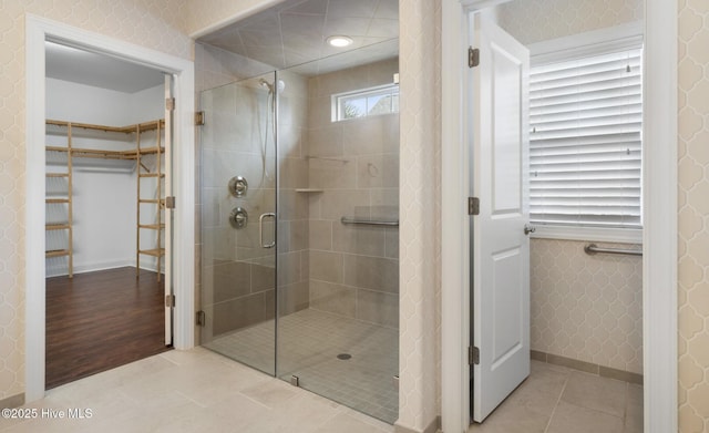 bathroom with tile patterned floors and a shower with shower door