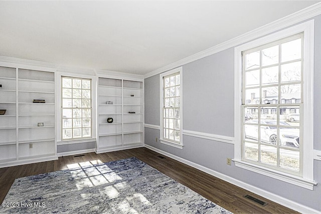 empty room featuring crown molding and dark wood-type flooring