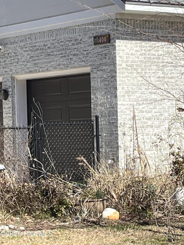 exterior details with fence and brick siding