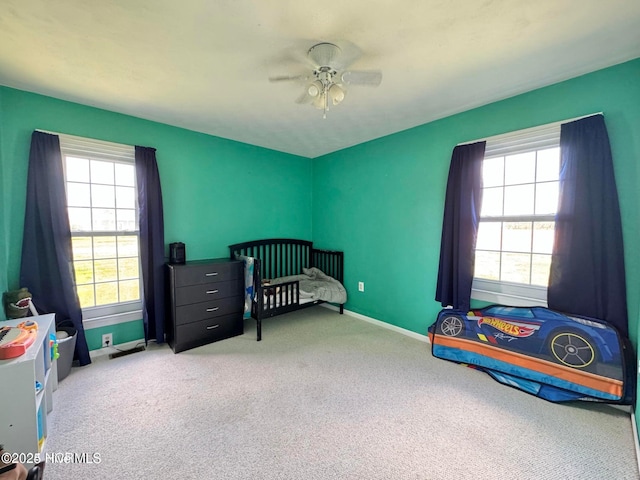 carpeted bedroom featuring ceiling fan