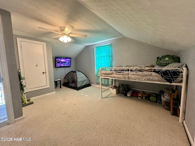 bedroom featuring ceiling fan, light colored carpet, lofted ceiling, and a textured ceiling