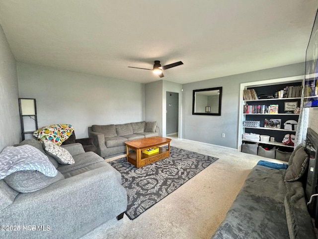 carpeted living room with ceiling fan