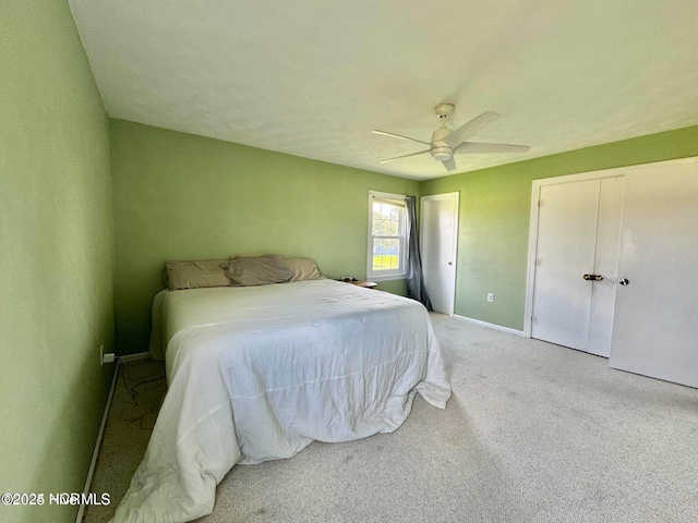 carpeted bedroom with multiple closets and ceiling fan