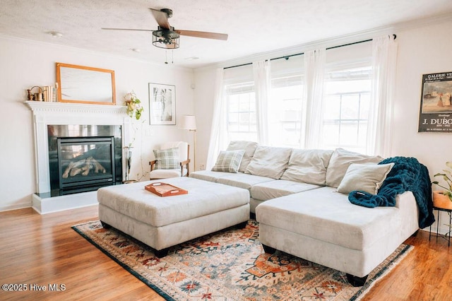 living room with ornamental molding, a healthy amount of sunlight, and hardwood / wood-style floors