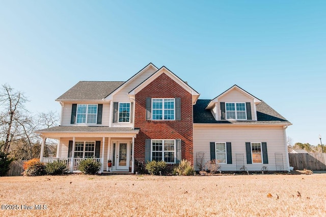 view of front facade with a front lawn and a porch