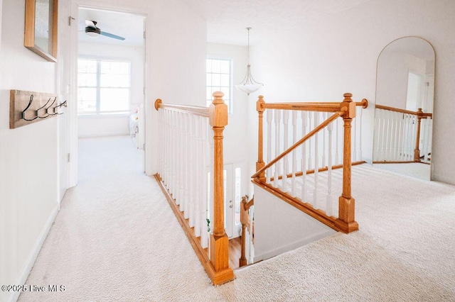 hall with light colored carpet