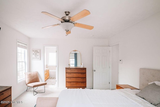 bedroom featuring ceiling fan and ensuite bath