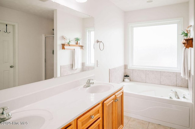 bathroom with tile patterned flooring, vanity, and separate shower and tub