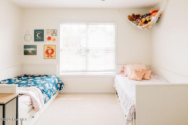 carpeted bedroom with multiple windows