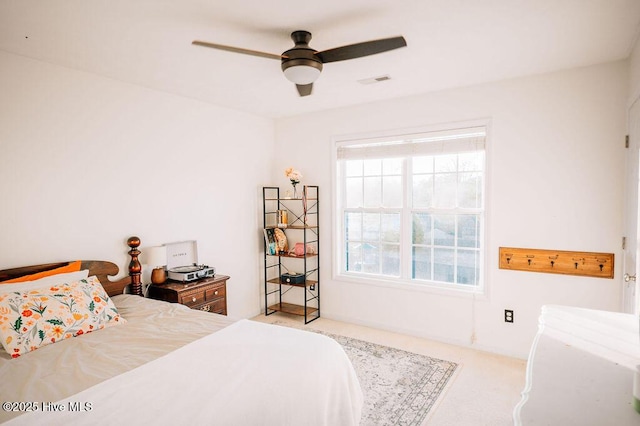 bedroom featuring light carpet and ceiling fan