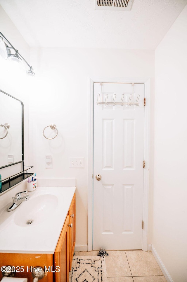 bathroom featuring tile patterned flooring and vanity