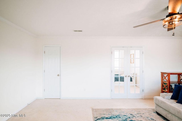 living room with french doors, light colored carpet, crown molding, and ceiling fan