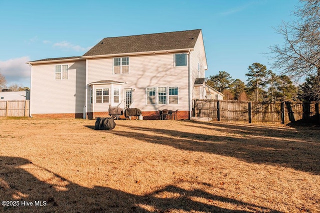 rear view of house with a yard