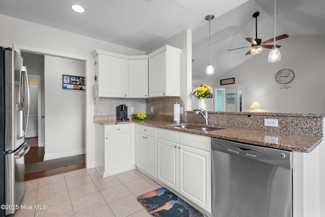 kitchen featuring stainless steel appliances, sink, white cabinets, and kitchen peninsula