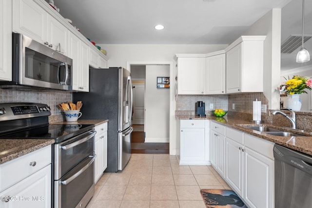 kitchen featuring appliances with stainless steel finishes, sink, and white cabinets