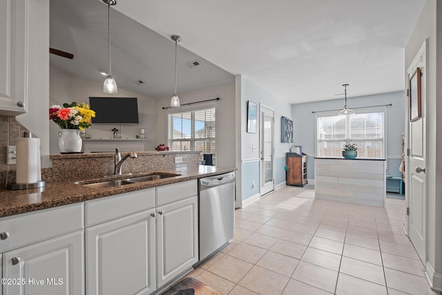 kitchen with white cabinetry, sink, dark stone countertops, hanging light fixtures, and stainless steel dishwasher