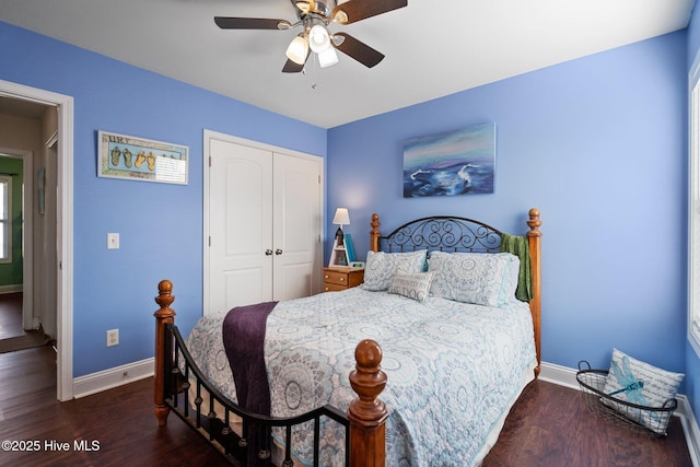 bedroom featuring a closet, dark hardwood / wood-style floors, and ceiling fan