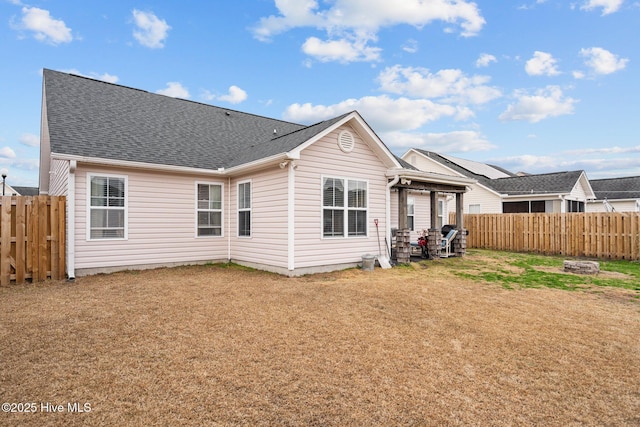 back of house with a lawn