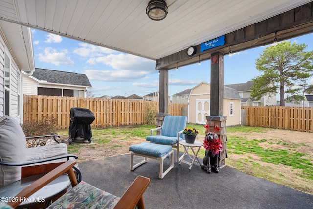 view of patio / terrace featuring a storage shed and grilling area