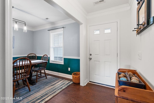 foyer featuring crown molding and dark hardwood / wood-style flooring