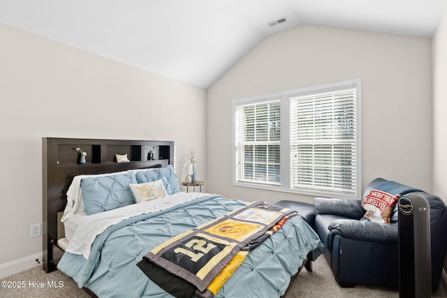 bedroom featuring lofted ceiling and light colored carpet