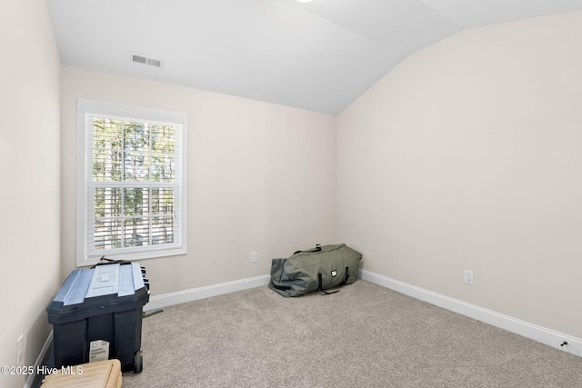 misc room featuring lofted ceiling and light colored carpet