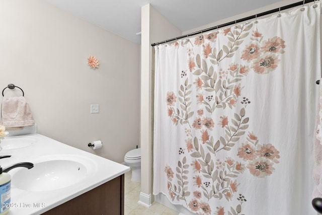 bathroom with vanity, toilet, and tile patterned flooring