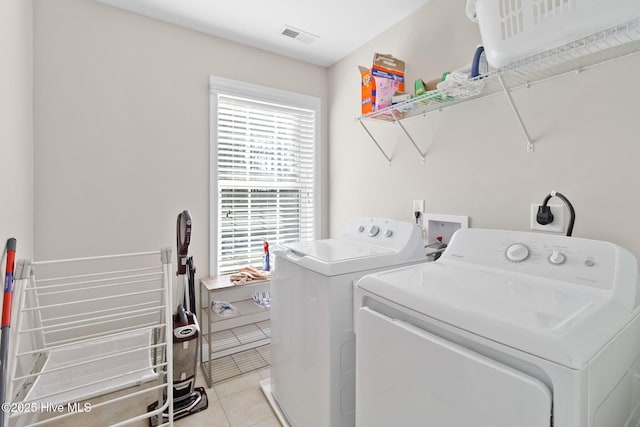 washroom with light tile patterned floors and independent washer and dryer