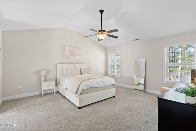 bedroom with lofted ceiling, light colored carpet, and ceiling fan