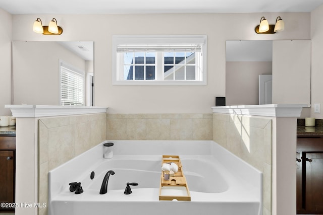 bathroom with a tub to relax in and vanity