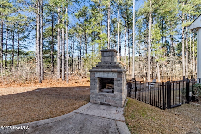 view of yard featuring an outdoor fireplace