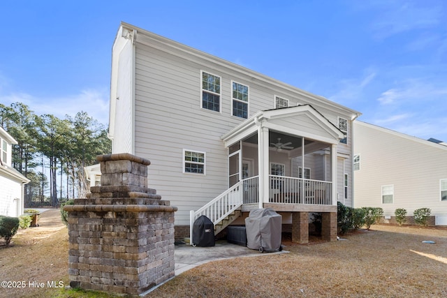 back of property featuring a sunroom and ceiling fan