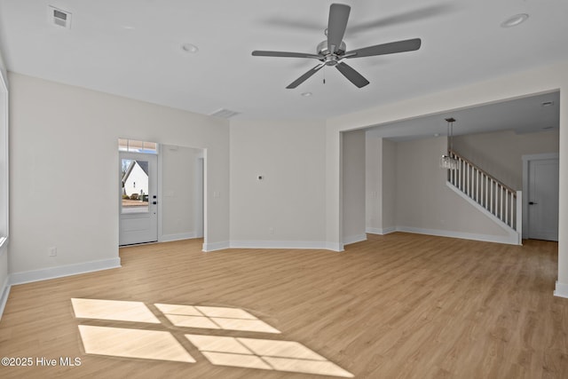 unfurnished living room featuring ceiling fan and light hardwood / wood-style floors