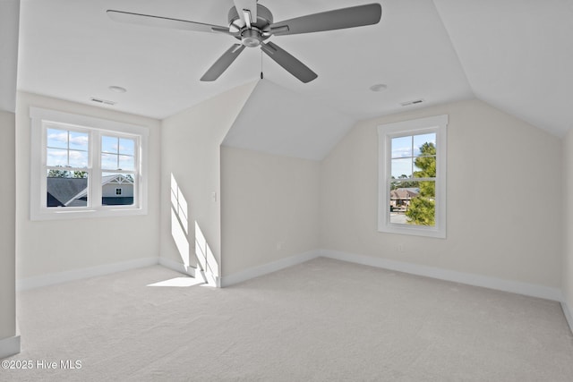 bonus room with ceiling fan, vaulted ceiling, and light carpet