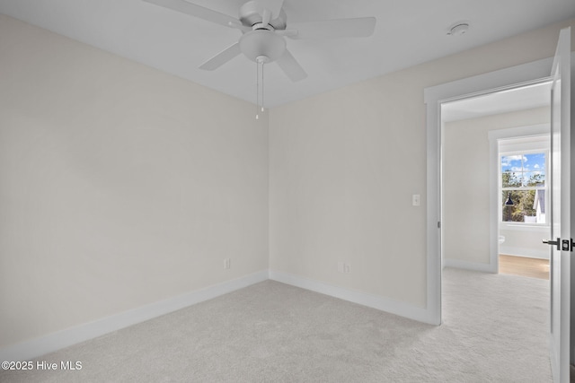 carpeted spare room with ceiling fan