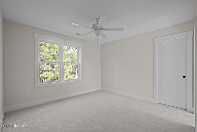 unfurnished room with light carpet and ceiling fan