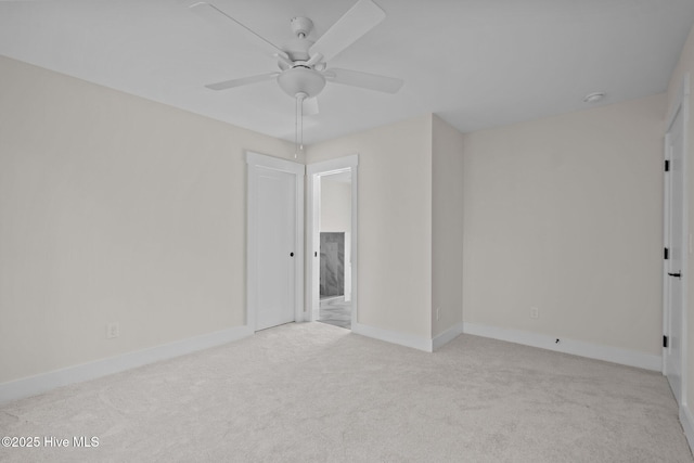 spare room featuring ceiling fan and light colored carpet