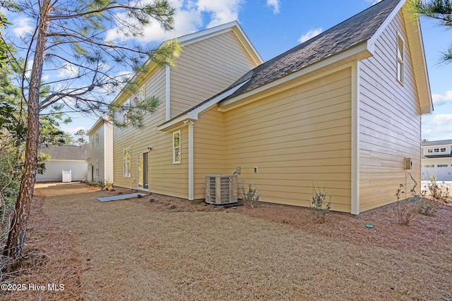 view of side of home with central AC