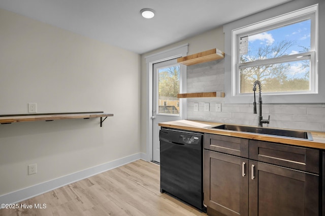 kitchen featuring sink, dishwasher, dark brown cabinetry, decorative backsplash, and light wood-type flooring