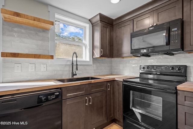 kitchen featuring dark brown cabinetry, wooden counters, sink, and black appliances