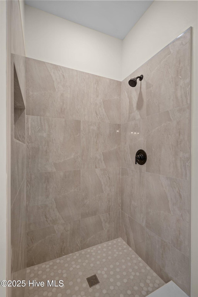 bathroom with a tile shower