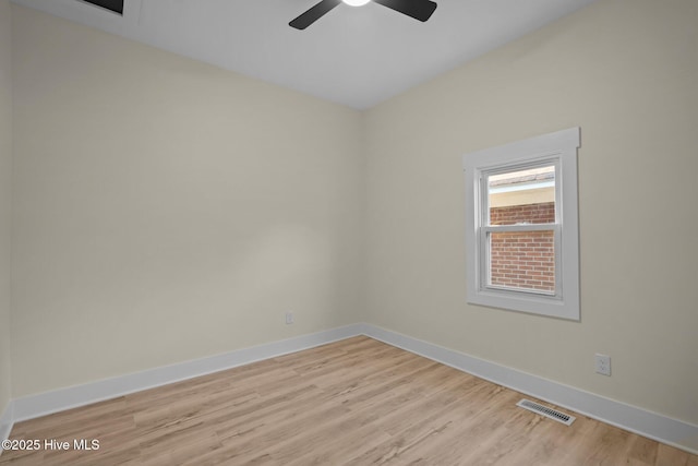 empty room with ceiling fan and light hardwood / wood-style floors