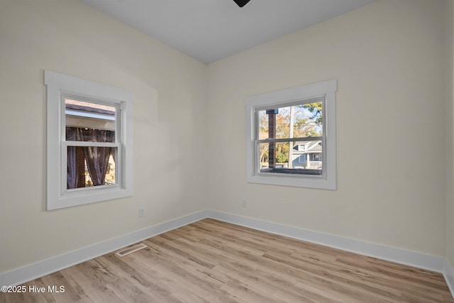 unfurnished room with ceiling fan and light wood-type flooring