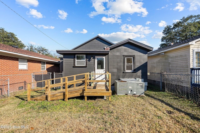 back of property with central AC, a yard, and a deck