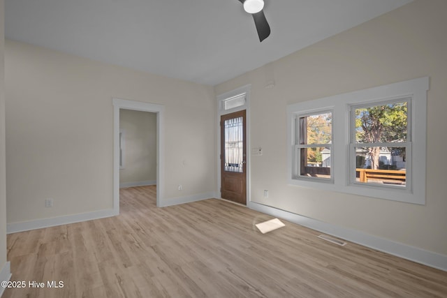 empty room featuring ceiling fan and light hardwood / wood-style flooring