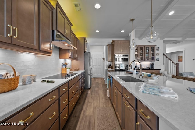 kitchen with sink, hanging light fixtures, dark hardwood / wood-style flooring, stainless steel appliances, and light stone countertops